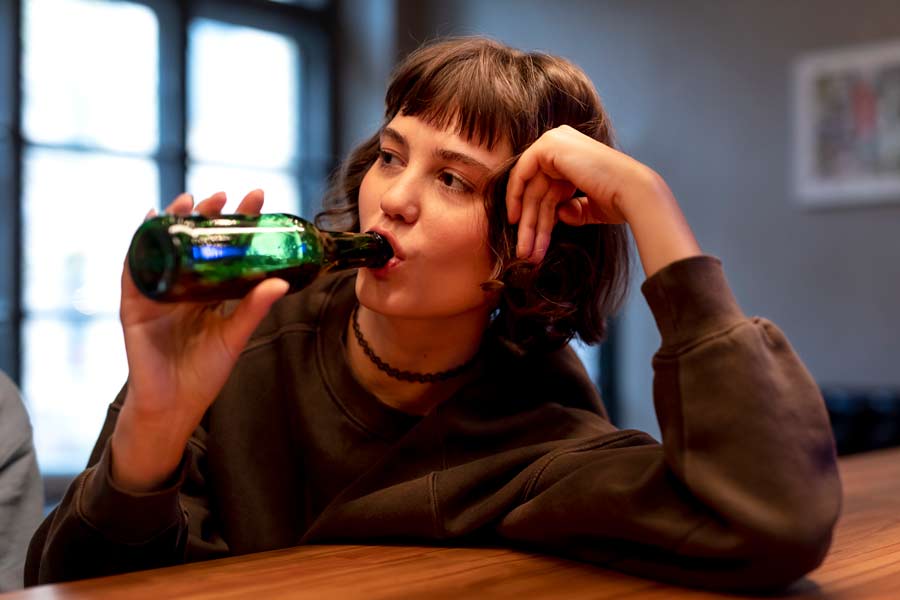 young-woman-drinking-beer-alone